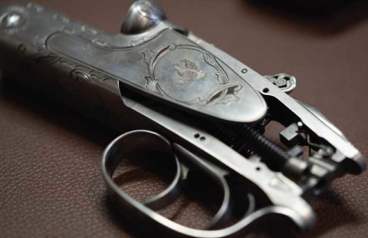 A raw shotgun action with two triggers on it,